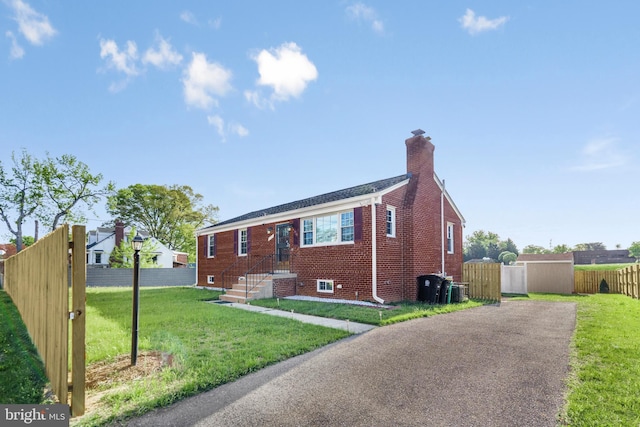 2124 Weber Dr, District Heights, MD 20747 - view of front of house featuring brick siding, a front yard, a chimney, and fence