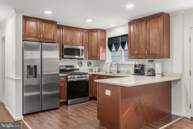 2124 Weber Dr, District Heights, MD 20747 - kitchen with a peninsula, dark wood-style floors, a sink, and appliances with stainless steel finishes