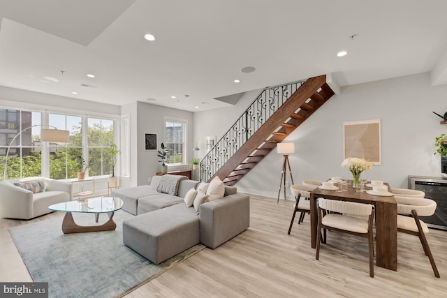 living room featuring stairway, recessed lighting, and wood finished floors
