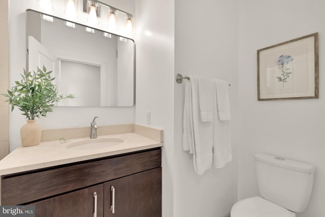 bathroom featuring toilet and vanity