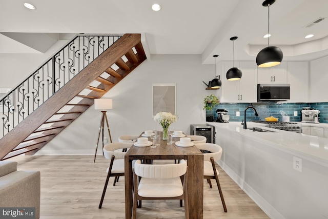 dining area featuring light wood-type flooring, recessed lighting, baseboards, and visible vents