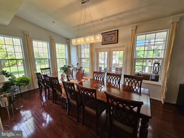 dining space with dark wood finished floors and lofted ceiling
