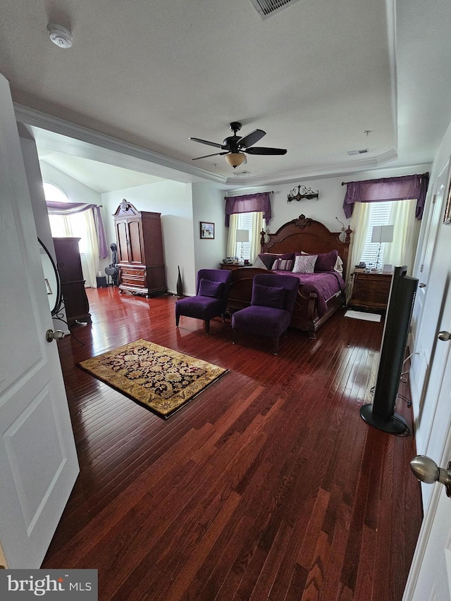 bedroom with ceiling fan, dark wood finished floors, multiple windows, and visible vents