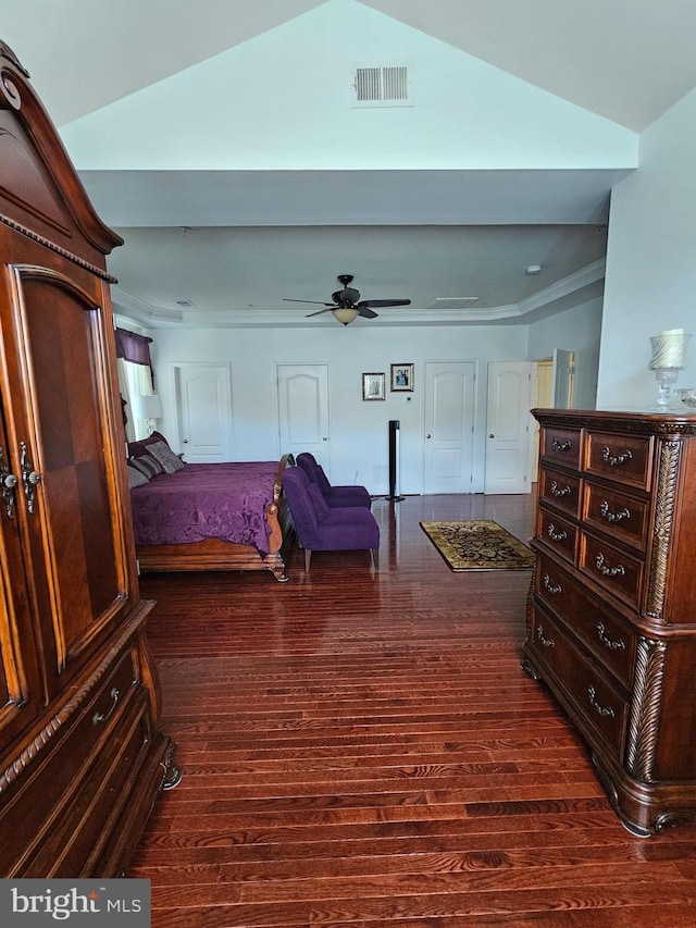 bedroom with crown molding, visible vents, and dark wood finished floors