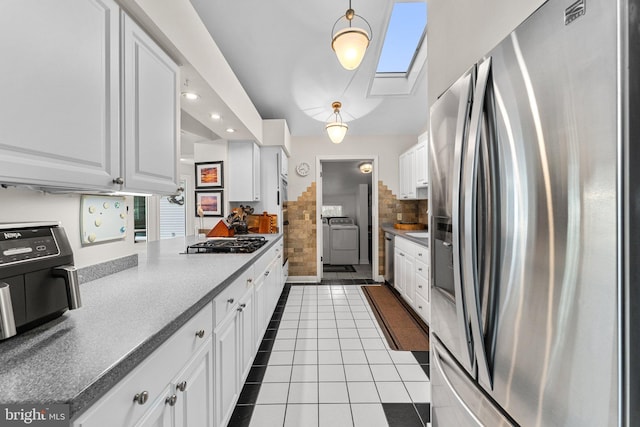 kitchen featuring dark tile patterned flooring, recessed lighting, white cabinets, and appliances with stainless steel finishes