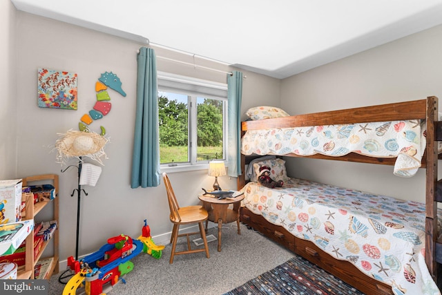 carpeted bedroom featuring baseboards