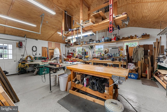 garage featuring a workshop area and wooden ceiling