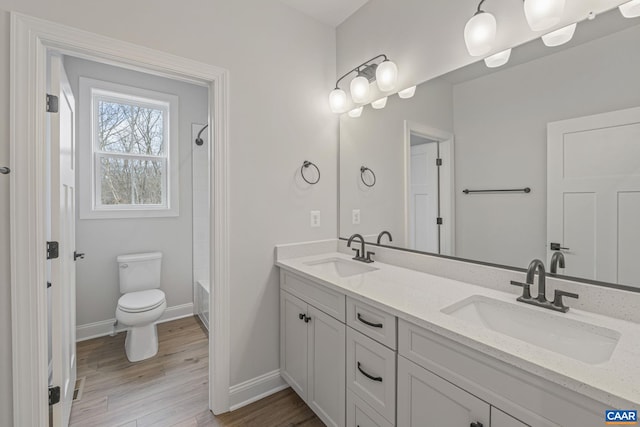 49C Fowler St, Charlottesville, VA 22901 - full bathroom with baseboards, wood finished floors, a sink, and toilet