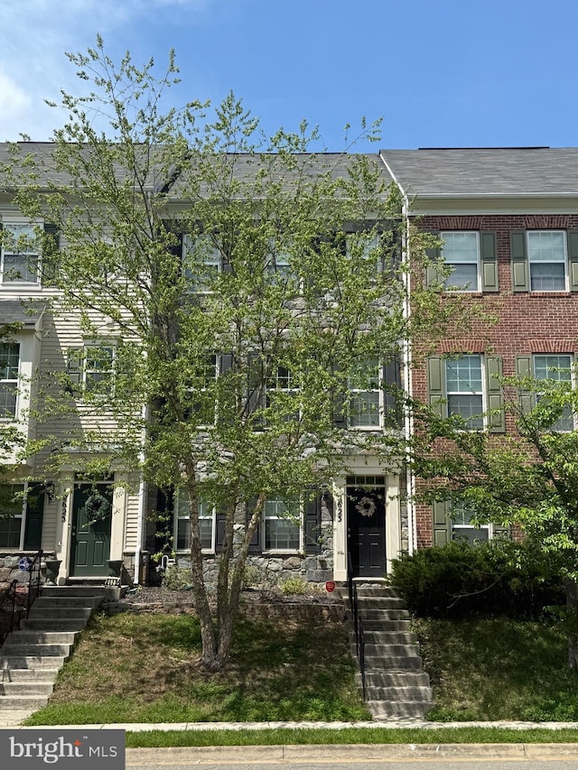 townhome / multi-family property with brick siding