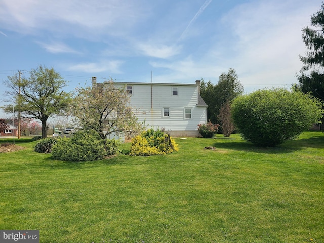 back of house featuring a lawn