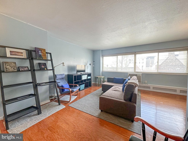 living area featuring a textured ceiling and wood finished floors