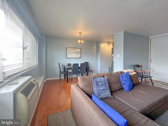 living room with baseboards and wood finished floors