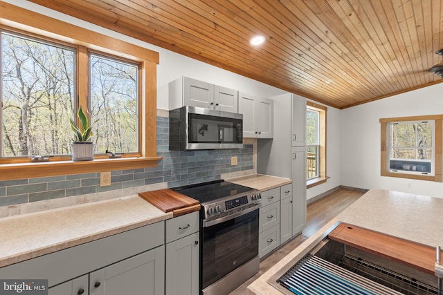 275 Oak Forest Ln, Berkeley Springs, WV 25411 - kitchen with wooden ceiling, decorative backsplash, appliances with stainless steel finishes, and light countertops