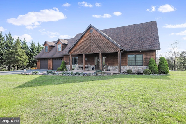 view of front of property featuring a porch, stone siding, driveway, and a front yard