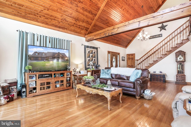 living room with an inviting chandelier, wood-type flooring, high vaulted ceiling, stairs, and wood ceiling