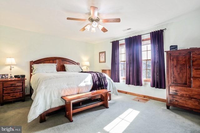carpeted bedroom featuring a ceiling fan, baseboards, and visible vents