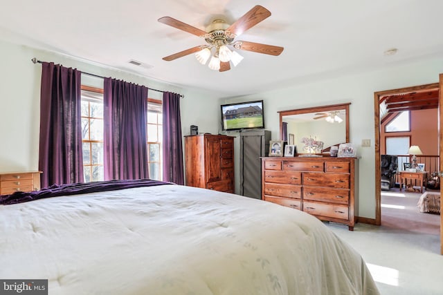 bedroom with carpet floors, multiple windows, ceiling fan, and visible vents