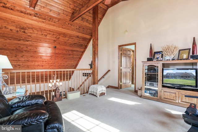 living area featuring carpet floors, lofted ceiling with beams, wood ceiling, and baseboards
