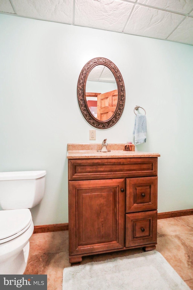 bathroom featuring vanity, baseboards, and toilet