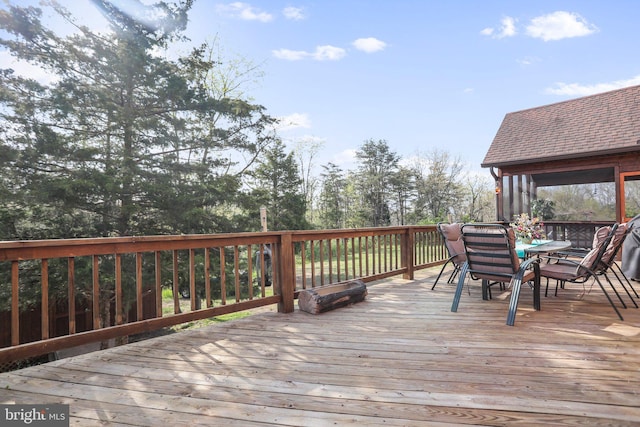wooden terrace featuring outdoor dining area