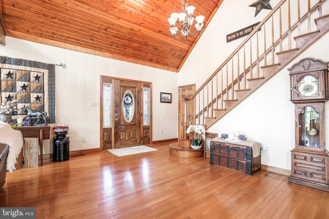 entrance foyer featuring wood-type flooring, baseboards, and high vaulted ceiling