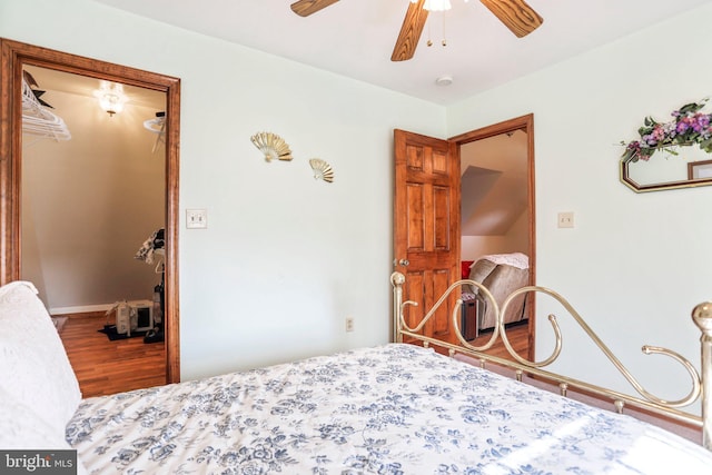 bedroom featuring baseboards, ceiling fan, and wood finished floors