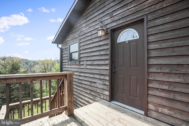 view of exterior entry with a deck