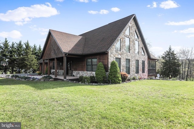 view of side of property with roof with shingles, a yard, and stone siding