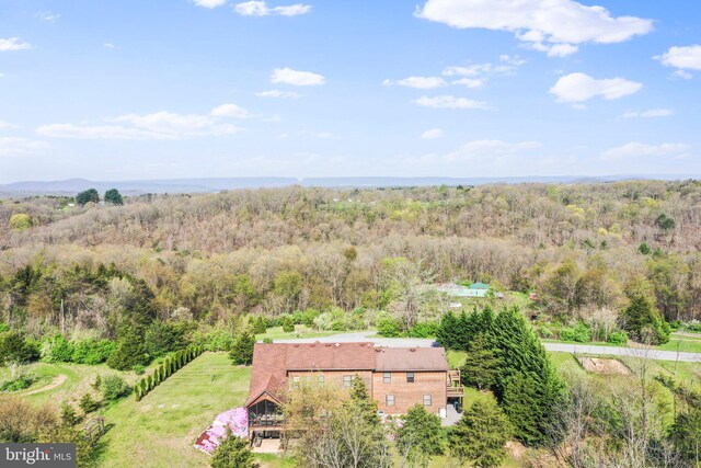 drone / aerial view featuring a view of trees