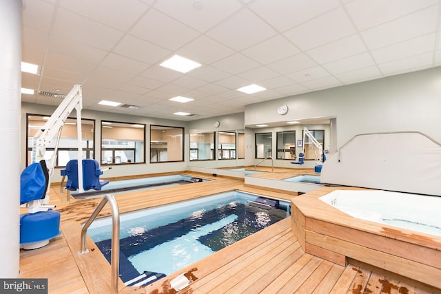 view of pool with an indoor hot tub