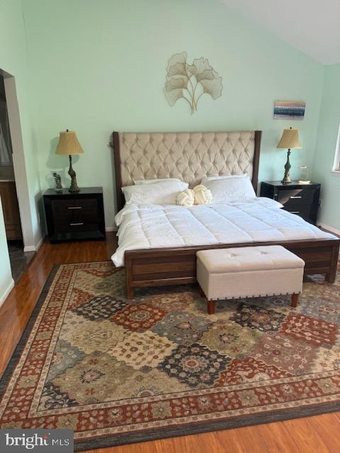 18413 Stone Hollow Dr, Germantown, MD 20874 - bedroom with wood finished floors, vaulted ceiling, and baseboards