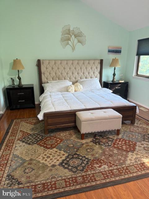 18413 Stone Hollow Dr, Germantown, MD 20874 - bedroom with wood finished floors, lofted ceiling, and baseboards