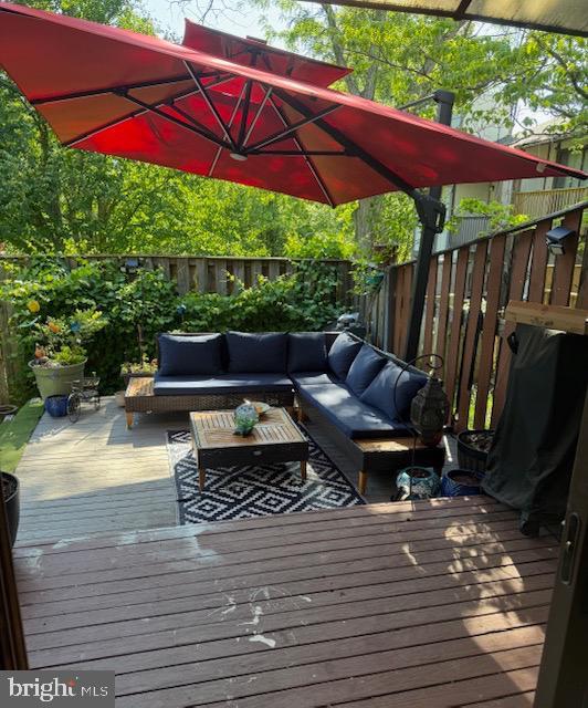 18413 Stone Hollow Dr, Germantown, MD 20874 - wooden deck with an outdoor living space and a fenced backyard