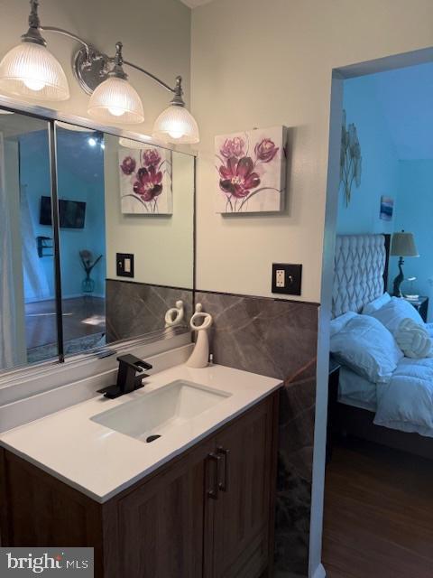 18413 Stone Hollow Dr, Germantown, MD 20874 - bathroom with tile walls, wood finished floors, and vanity