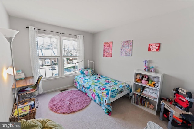 carpeted bedroom with baseboards and visible vents