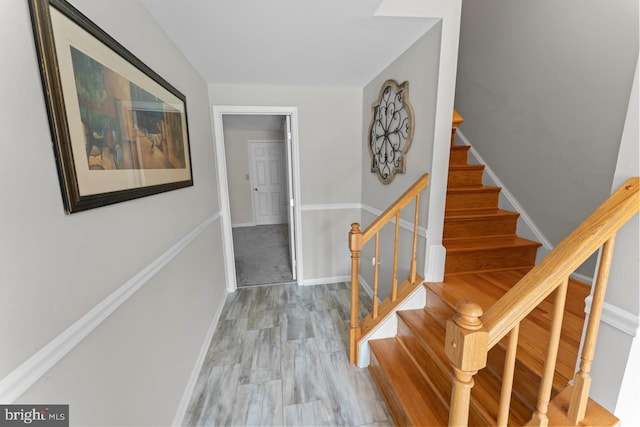 interior space featuring baseboards and stairway