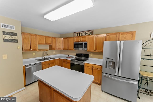 kitchen with appliances with stainless steel finishes, visible vents, light floors, and a sink