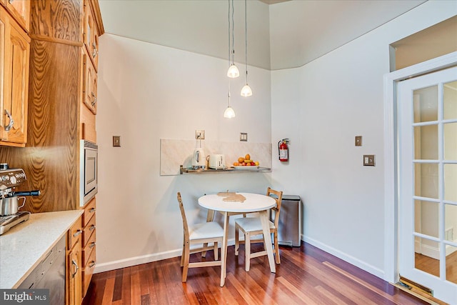 dining room with baseboards and dark wood-style floors