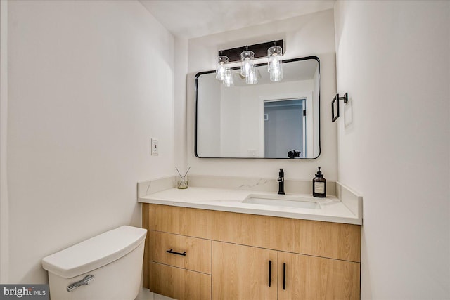 bathroom featuring toilet and vanity