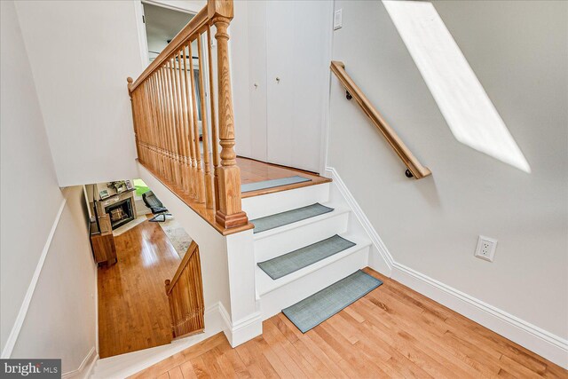 stairs featuring baseboards and wood finished floors