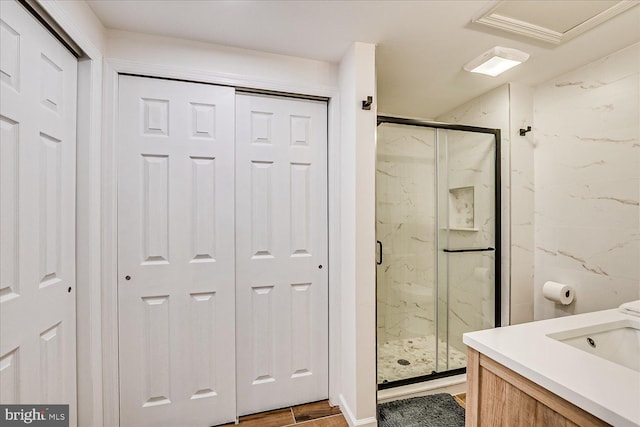 full bathroom with vanity, wood finished floors, and a marble finish shower