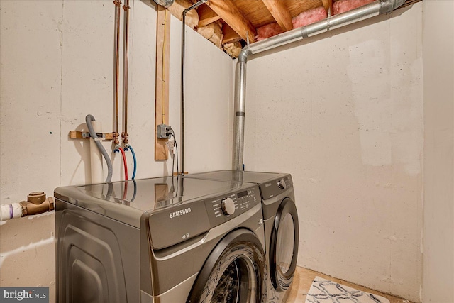 clothes washing area with independent washer and dryer and laundry area