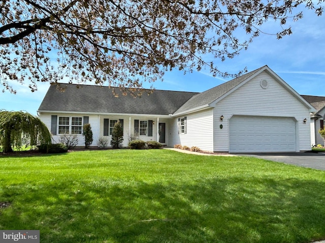 ranch-style house featuring a garage, driveway, and a front yard