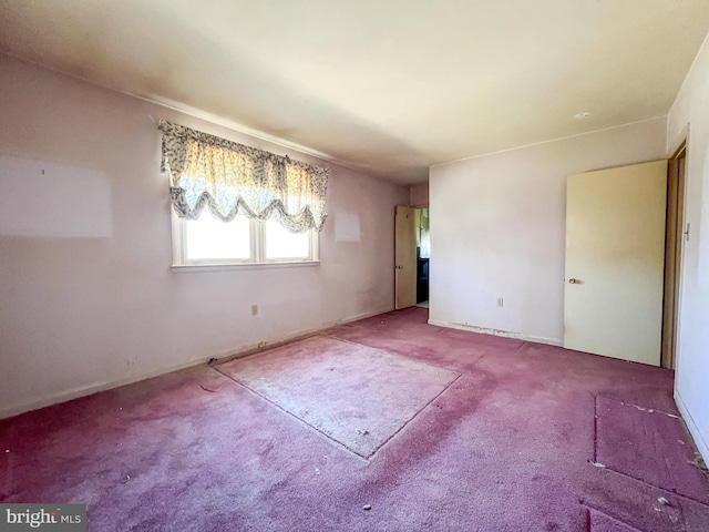 unfurnished room featuring carpet