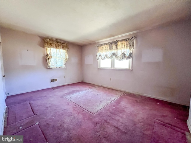 unfurnished dining area featuring baseboards, carpet, and visible vents