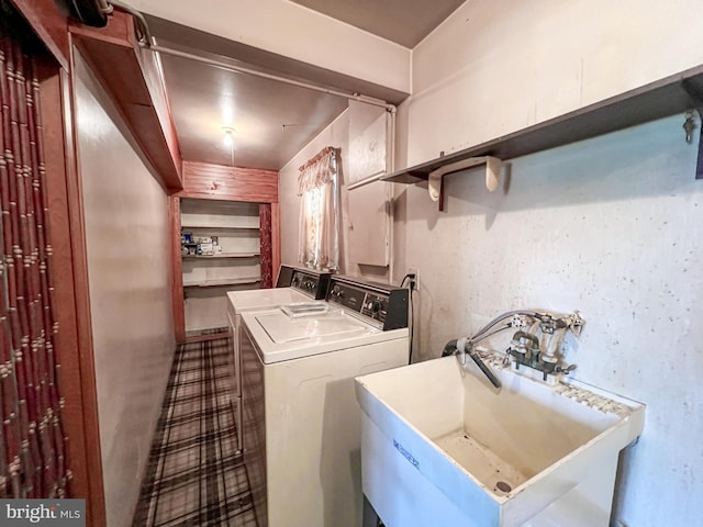 laundry room with laundry area, a sink, and washer and dryer