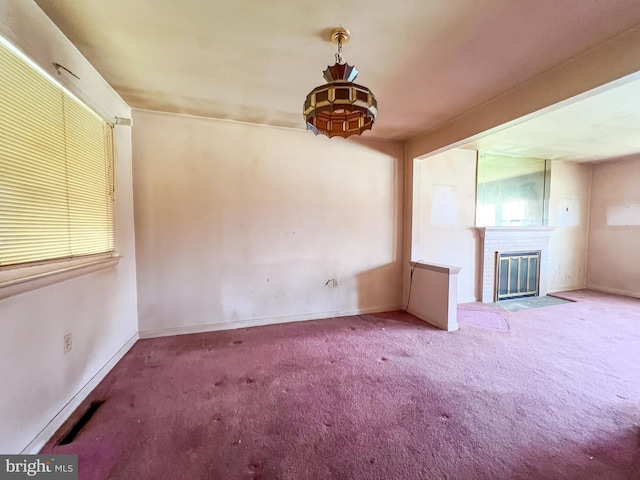 unfurnished living room featuring visible vents, carpet flooring, baseboards, and a fireplace