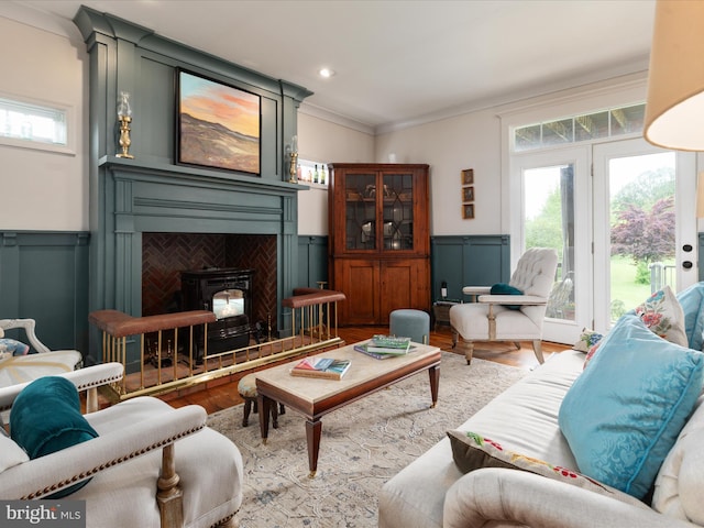 living area featuring plenty of natural light, a wainscoted wall, and wood finished floors