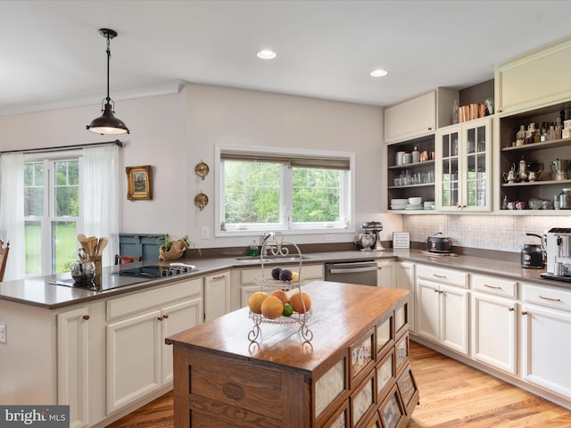 kitchen featuring black electric cooktop, stainless steel dishwasher, a sink, open shelves, and dark countertops