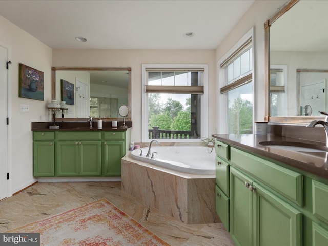 full bathroom with marble finish floor, a healthy amount of sunlight, vanity, and a bath